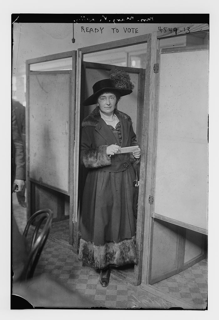 Photograph of a woman waiting to vote